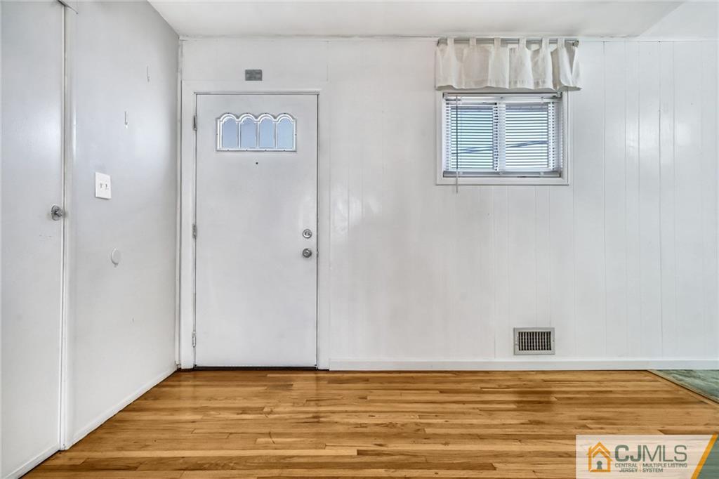 3020 Cheesequake Road Old Bridge, NJ 08859 - Photo 2 of 25 a view of an empty room with window and wooden floor