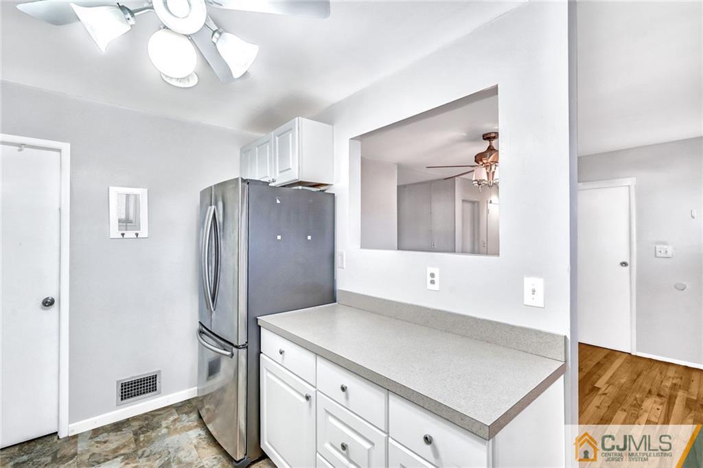 3020 Cheesequake Road Old Bridge, NJ 08859 - Photo 11 of 25 a kitchen with stainless steel appliances a refrigerator and a chandelier