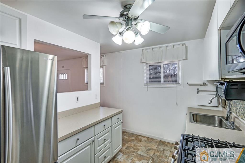 3020 Cheesequake Road Old Bridge, NJ 08859 - Photo 12 of 25 a kitchen with cabinets and wooden floor