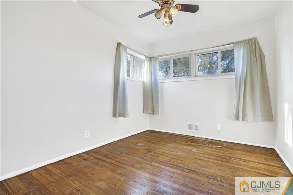 3020 Cheesequake Road Old Bridge, NJ 08859 - Photo 14 of 25 a view of empty room with wooden floor and fan