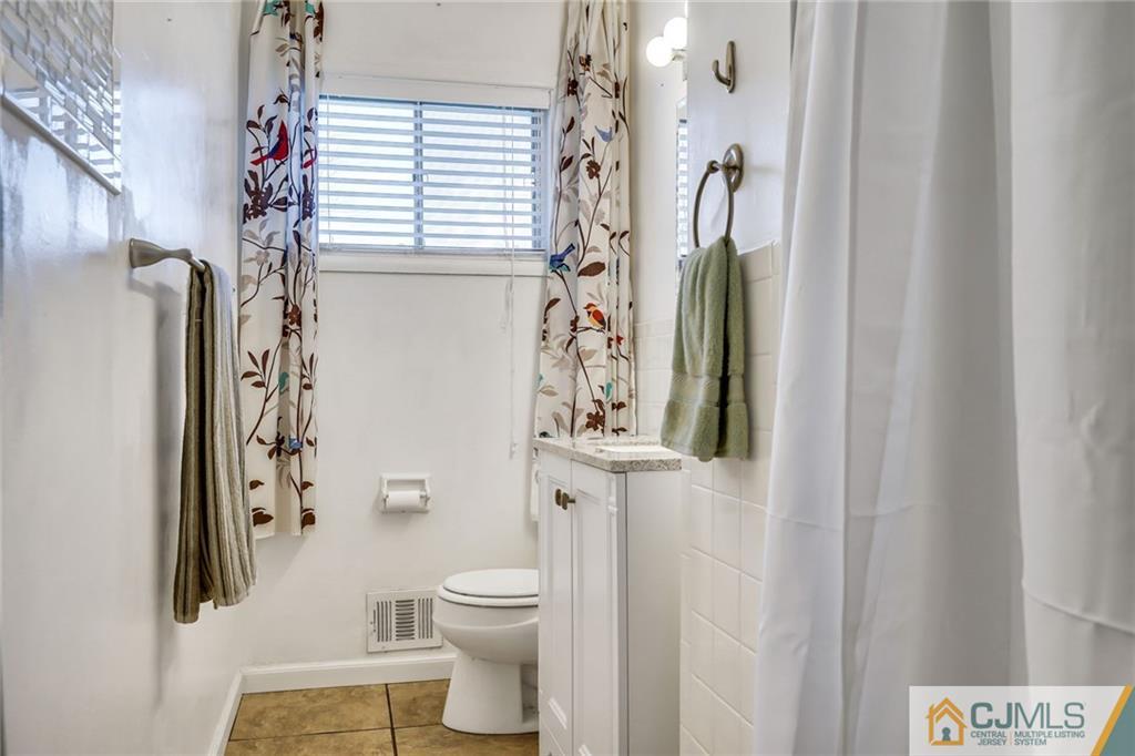 3020 Cheesequake Road Old Bridge, NJ 08859 - Photo 15 of 25 a white toilet sitting next to a shower curtain