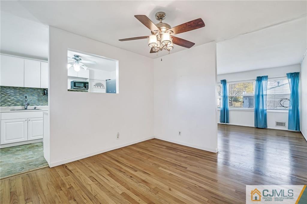 3020 Cheesequake Road Old Bridge, NJ 08859 - Photo 4 of 25 a view of an empty room with wooden floor and a window