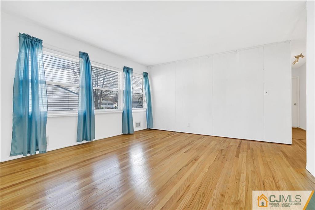 3020 Cheesequake Road Old Bridge, NJ 08859 - Photo 9 of 25 a view of an empty room with wooden floor and a window