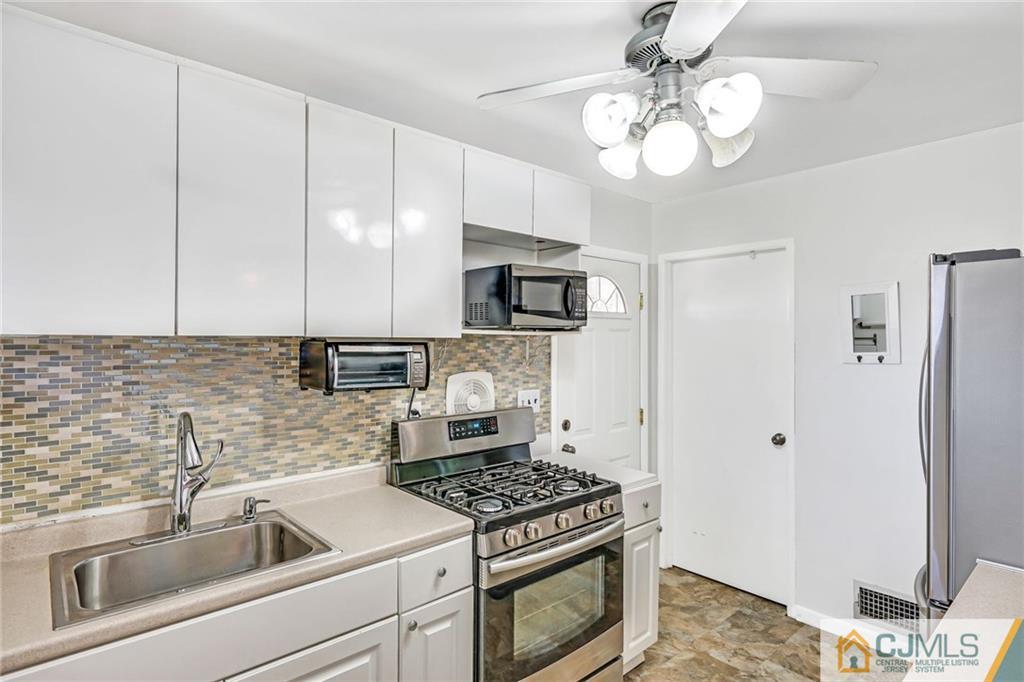 3020 Cheesequake Road Old Bridge, NJ 08859 - Photo 10 of 25 a kitchen with stainless steel appliances granite countertop a sink a stove and a refrigerator