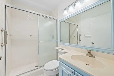 a bathroom with a sink toilet and shower