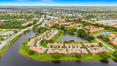 an aerial view of residential houses with outdoor space and swimming pool