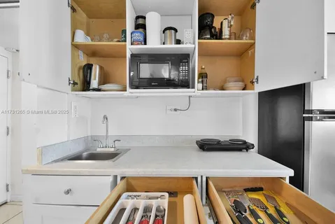 a kitchen with a refrigerator and a sink