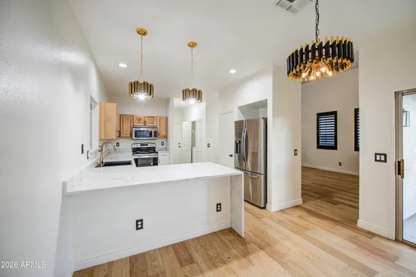 a large kitchen with a large refrigerator a oven and a sink