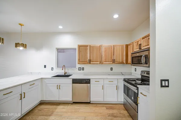 a kitchen with a sink a stove and cabinets