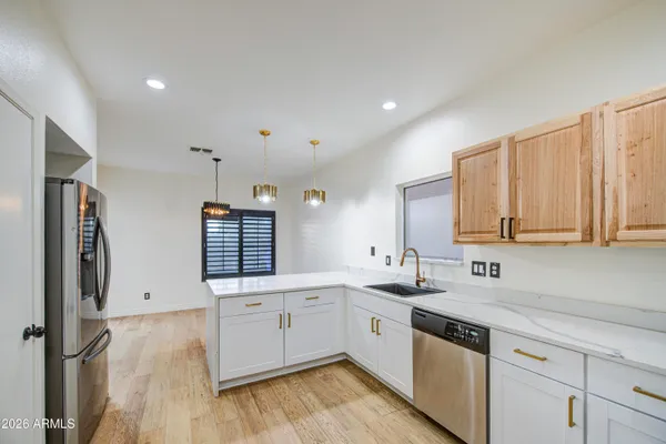 a kitchen with a sink cabinets and window