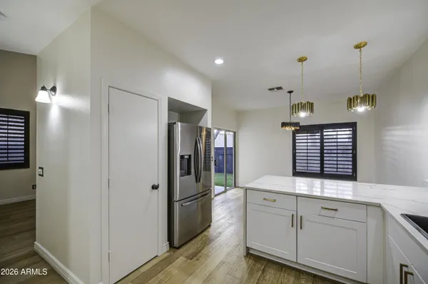 a kitchen with white cabinets and stainless steel appliances