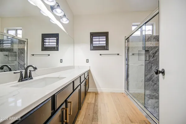 a bathroom with a double vanity sink and a mirror