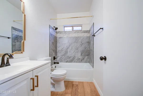 a bathroom with a sink a toilet and a bathtub