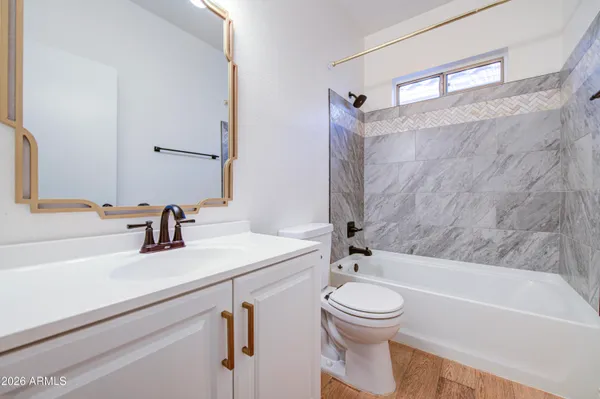 a bathroom with a sink a toilet and mirror