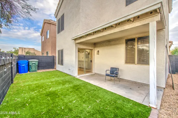 a view of a backyard with wooden fence
