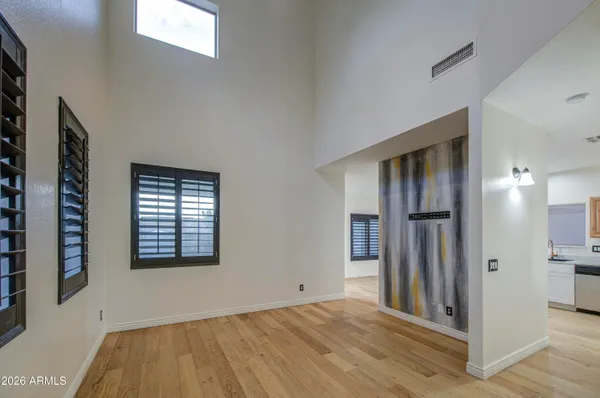 a view of an empty room with a fireplace and a window