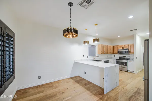 a view of kitchen with stainless steel appliances sink cabinets and stove