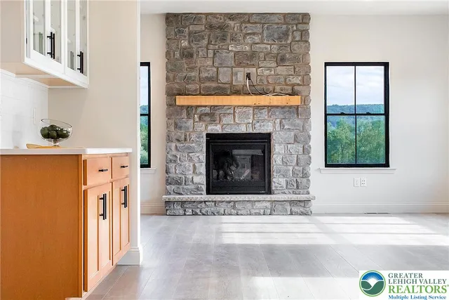 a living room with a fireplace and a wooden floor
