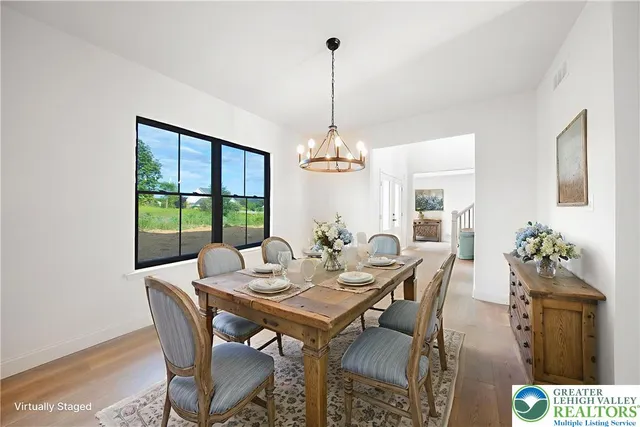 a view of a dining room with furniture wooden floor and chandelier