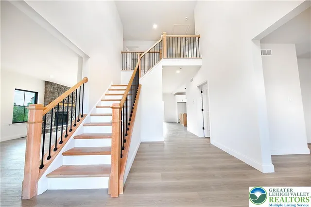 a view of staircase with lots of frames and wooden floor