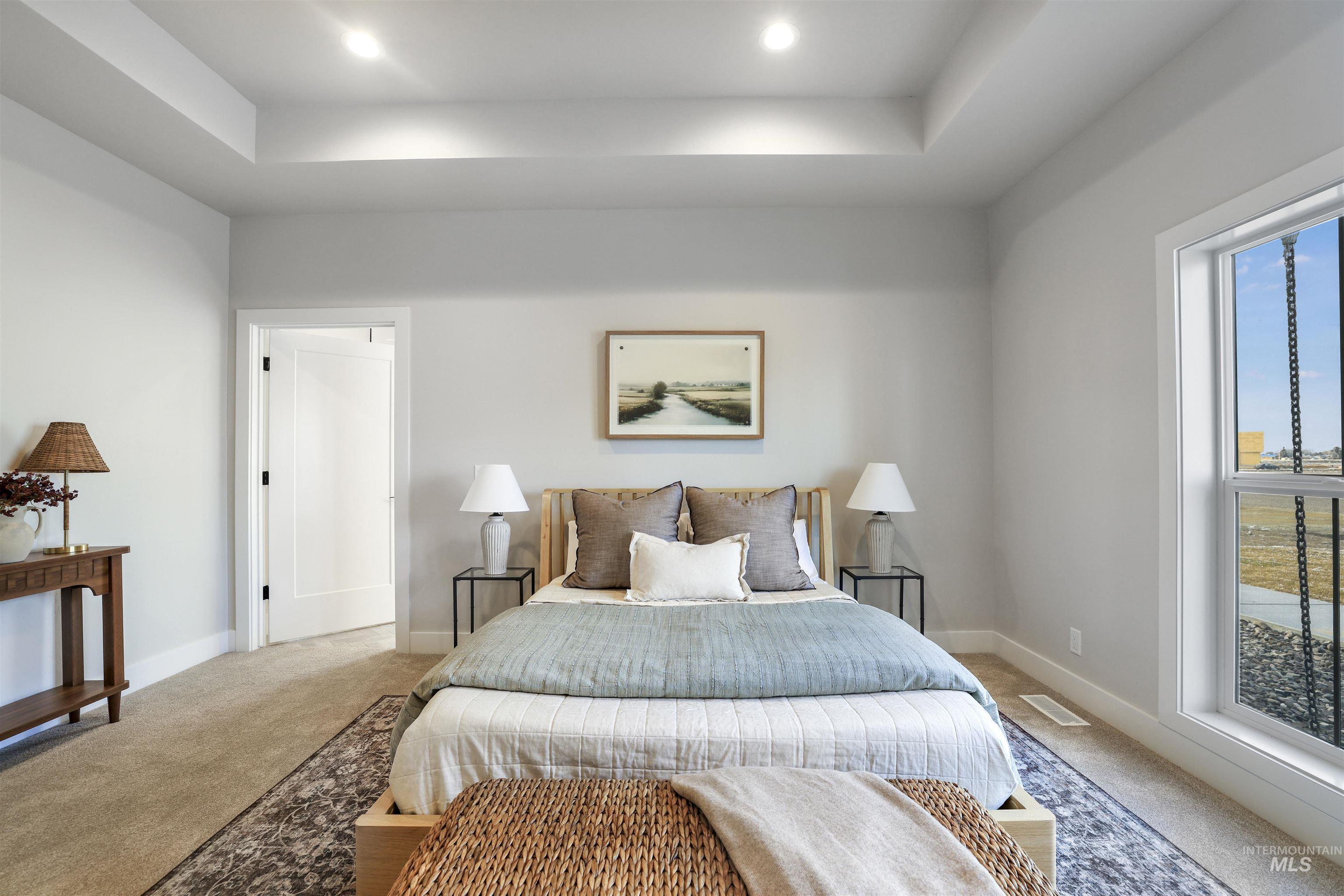 262 Ferdinand Circle Burley, ID 83318 - Photo 21 of 50 Carpeted bedroom with a tray ceiling and recessed lighting