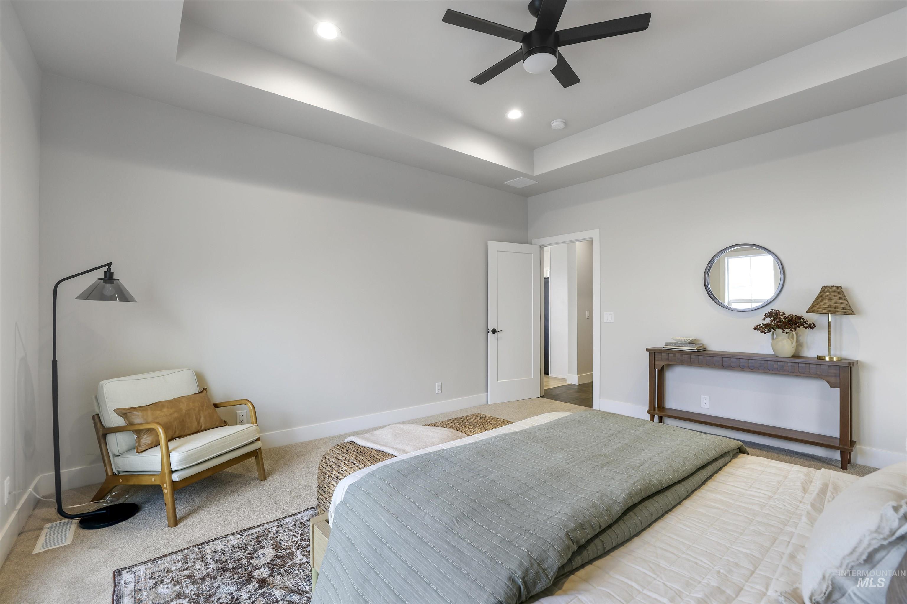 262 Ferdinand Circle Burley, ID 83318 - Photo 22 of 50 Carpeted bedroom featuring a tray ceiling, recessed lighting, and a ceiling fan