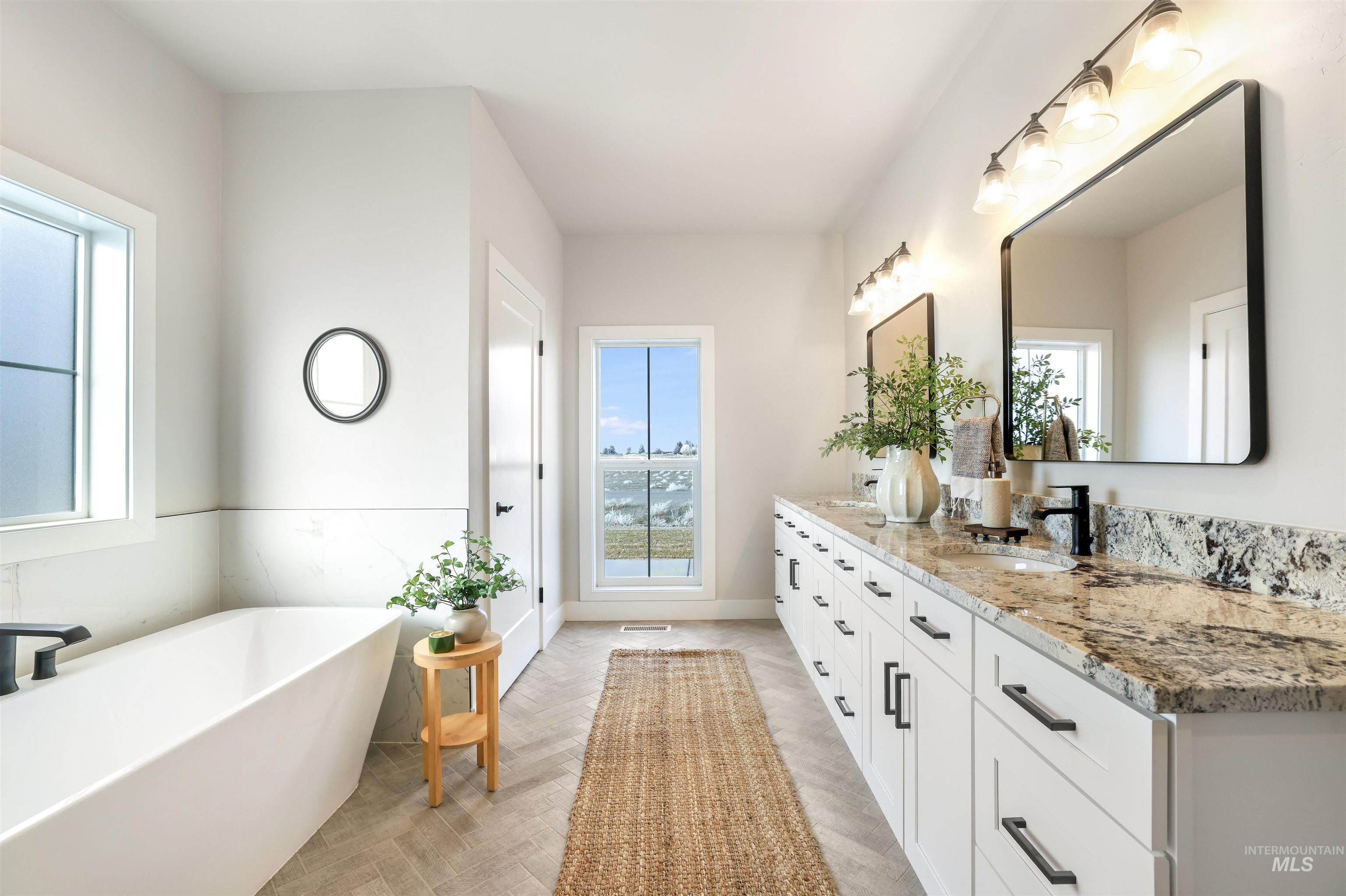 262 Ferdinand Circle Burley, ID 83318 - Photo 23 of 50 Full bath featuring double vanity, a soaking tub, and parquet floors