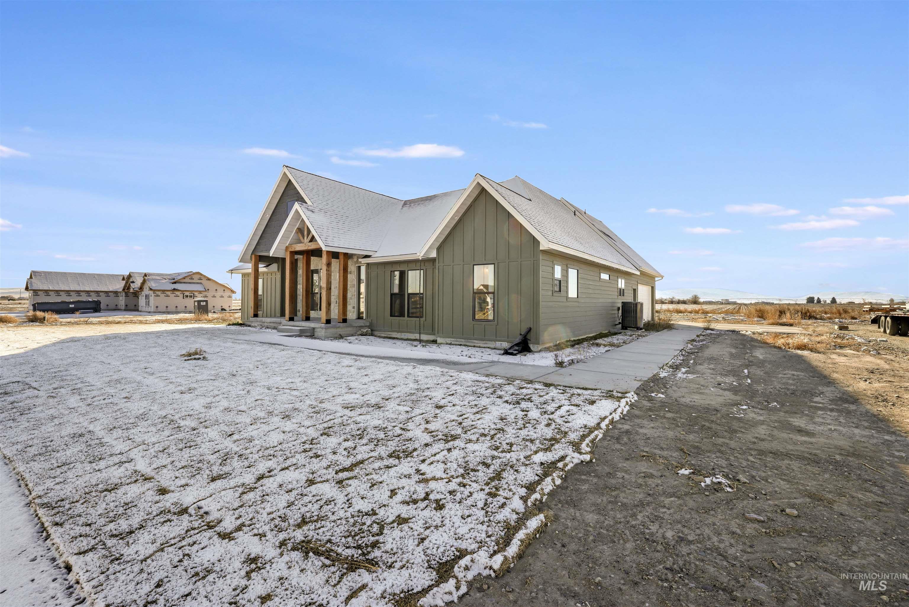 262 Ferdinand Circle Burley, ID 83318 - Photo 40 of 50 View of side of home featuring board and batten siding and a cooling unit