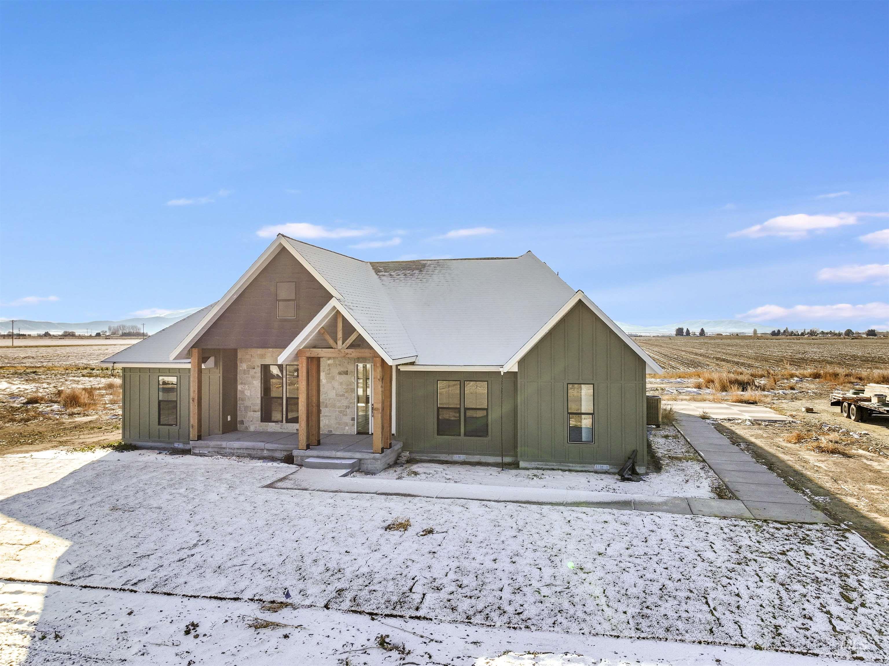 262 Ferdinand Circle Burley, ID 83318 - Photo 42 of 50 View of front of property featuring covered porch, a rural view, board and batten siding, and a mountain view