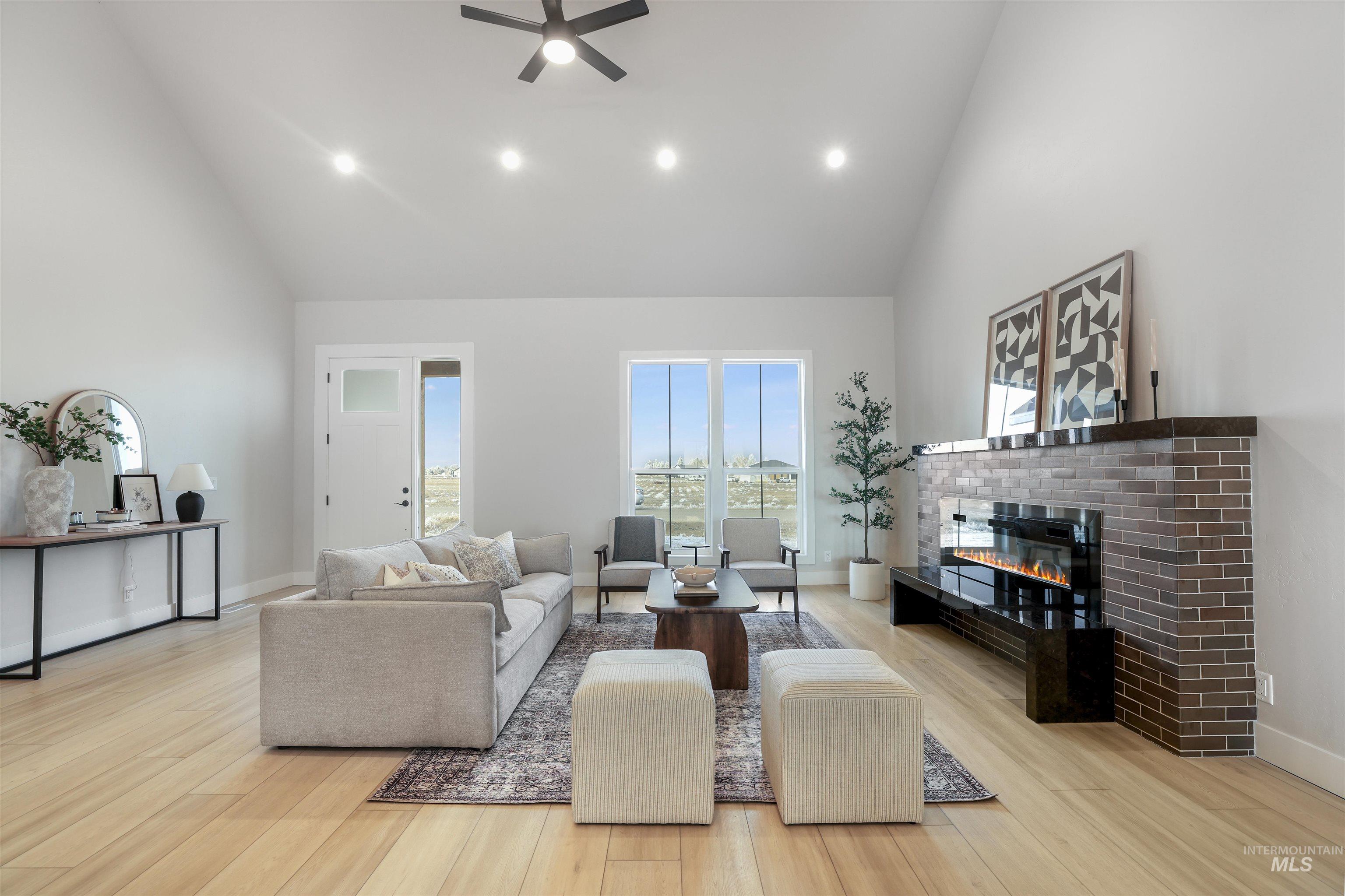 262 Ferdinand Circle Burley, ID 83318 - Photo 8 of 50 Living room with high vaulted ceiling, a brick fireplace, light wood finished floors, recessed lighting, and ceiling fan