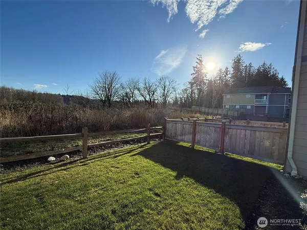 a view of a backyard with plants and a lake