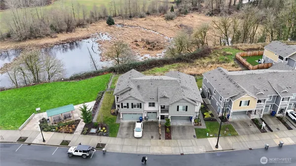 an aerial view of a house with garden space and street view