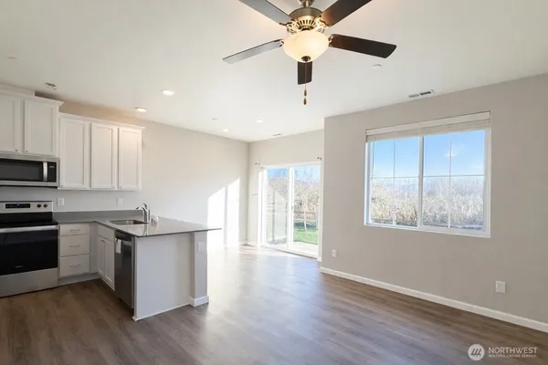 a kitchen with stainless steel appliances granite countertop a stove and a refrigerator