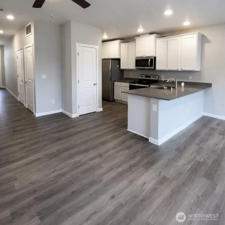 a kitchen with stainless steel appliances granite countertop a stove and a refrigerator