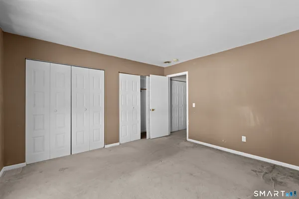 a view of an empty room and closet area