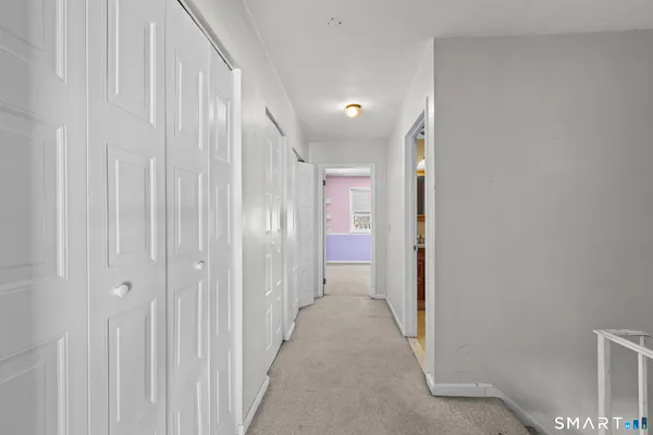 a view of a hallway with closet area