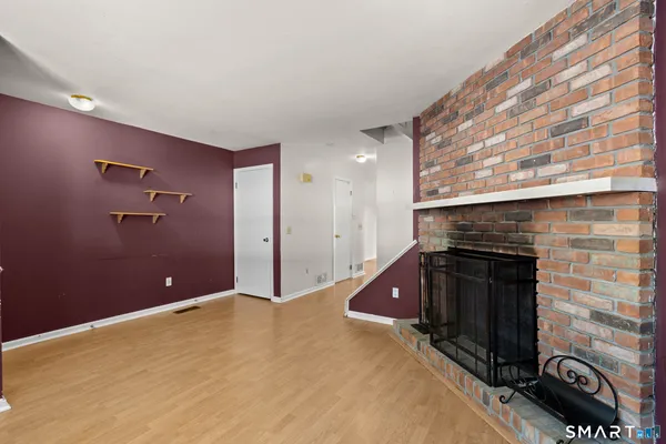 a bedroom with a bed and a fireplace