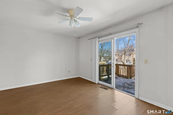 an empty room with chandelier fan