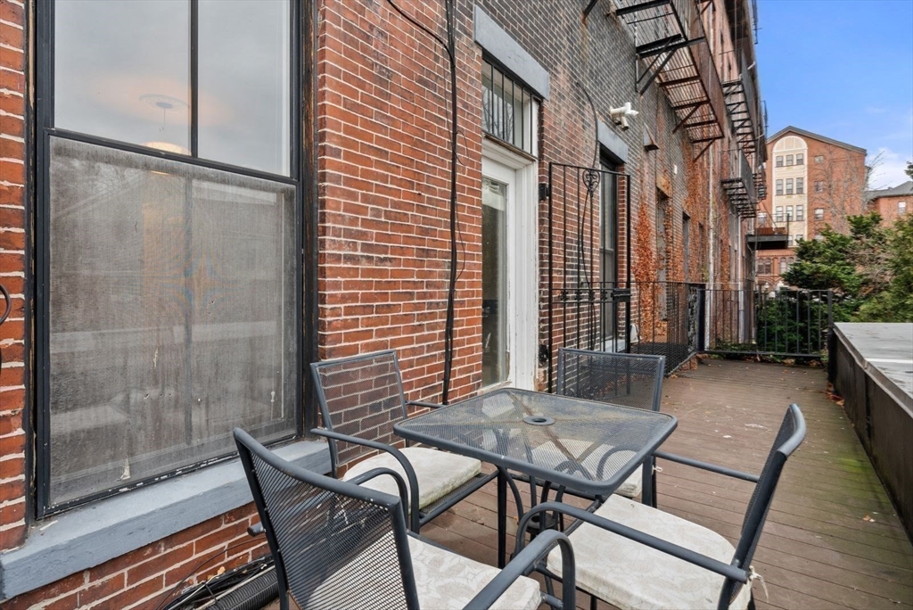 662 Tremont Street, Unit 3 Boston, MA 02118 - Photo 14 of 15 a view of a patio with a table and chairs