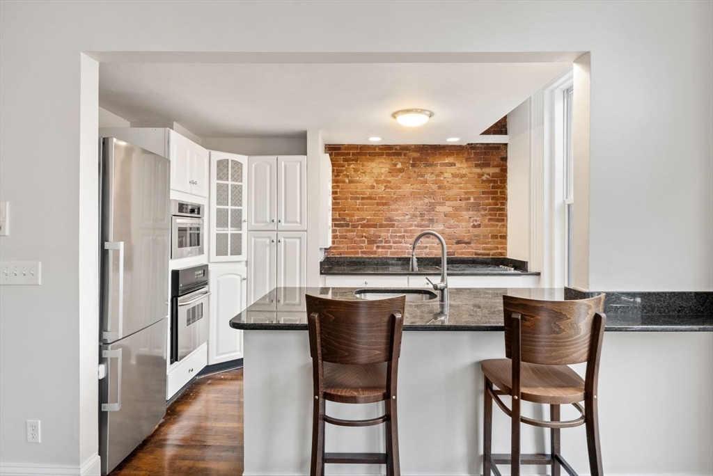 662 Tremont Street, Unit 3 Boston, MA 02118 - Photo 5 of 15 a kitchen with a window and chairs