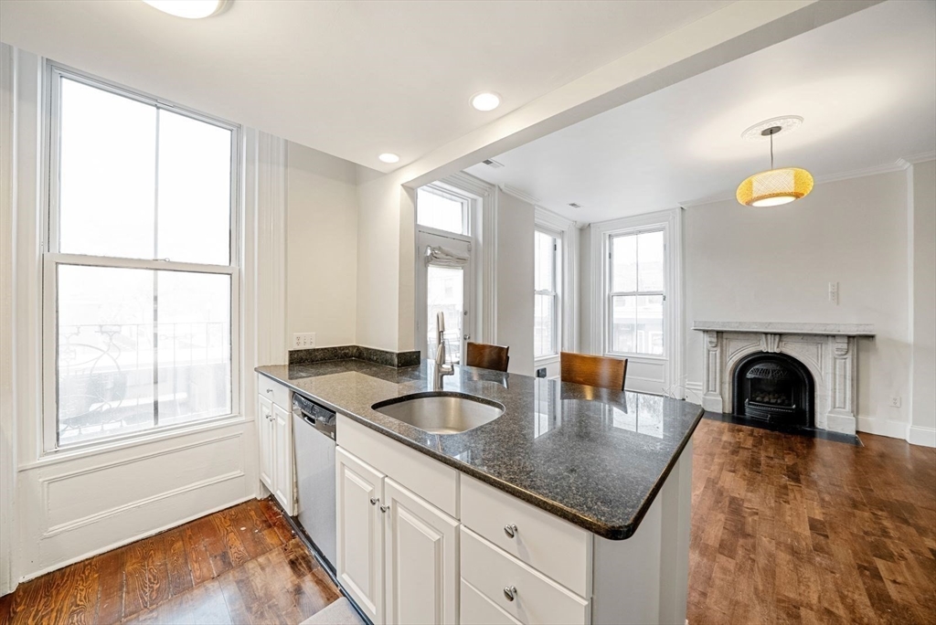 662 Tremont Street, Unit 3 Boston, MA 02118 - Photo 7 of 15 a kitchen with granite countertop a sink and a window