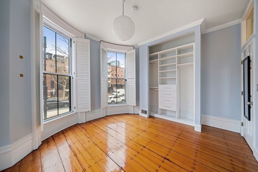 662 Tremont Street, Unit 3 Boston, MA 02118 - Photo 9 of 15 a view of an empty room with wooden floor and a window