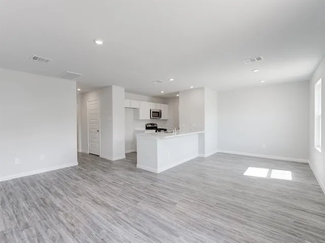 a view of kitchen with refrigerator and window