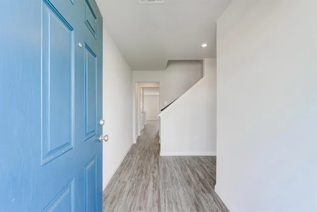 a view of a hallway with wooden floor