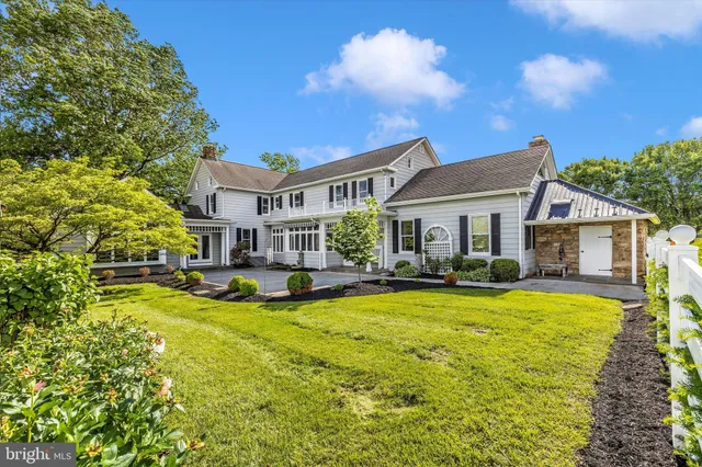 a living room with furniture a fireplace and a large window