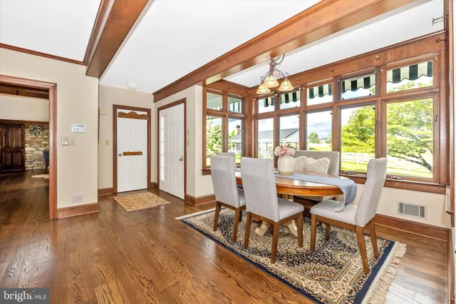 a living room with furniture a wooden floor and next to a window