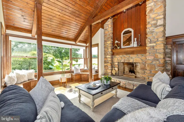 a living room with furniture and a mirror