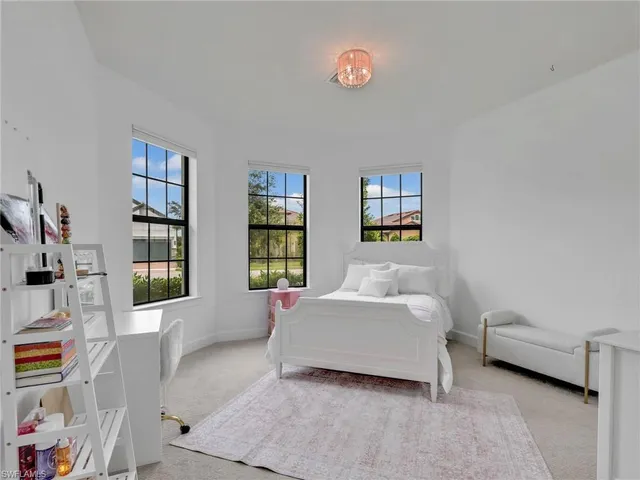 a spacious bedroom with a bed and a window