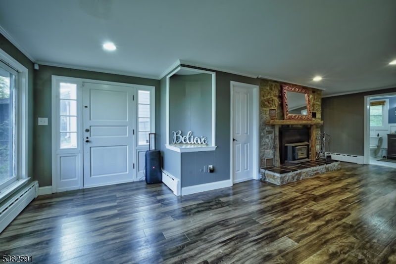 49 Mt Pleasant Road Columbia, NJ 07832 - Photo 23 of 47 an empty room with wooden floor fireplace and windows