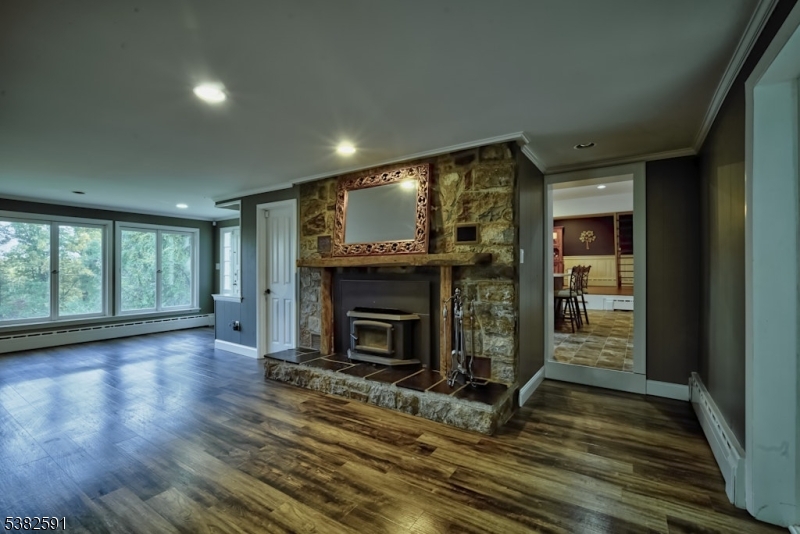 49 Mt Pleasant Road Columbia, NJ 07832 - Photo 24 of 47 an empty room with wooden floor fireplace and windows